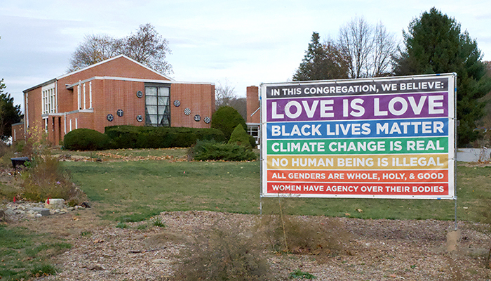 uucw church exterior showing "love is Love" sign